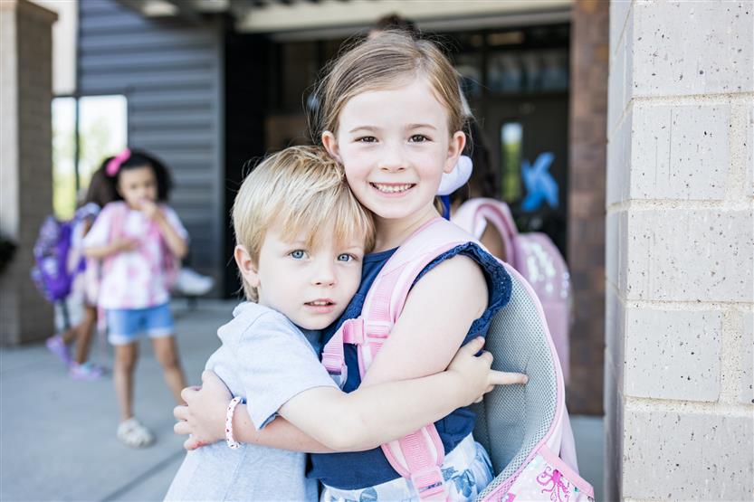 Two students smile